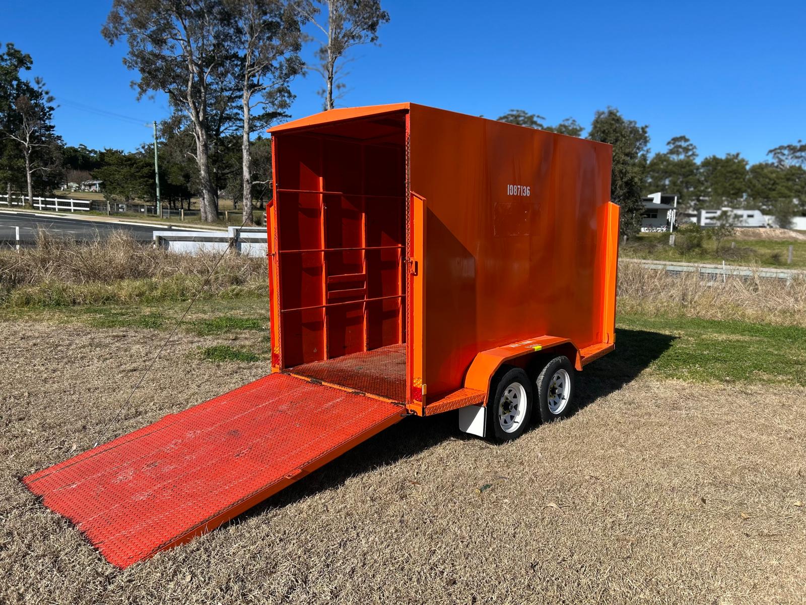 Stafford’s enclosed hire trailer with rear ramp open, showing spacious interior for moving and transport.