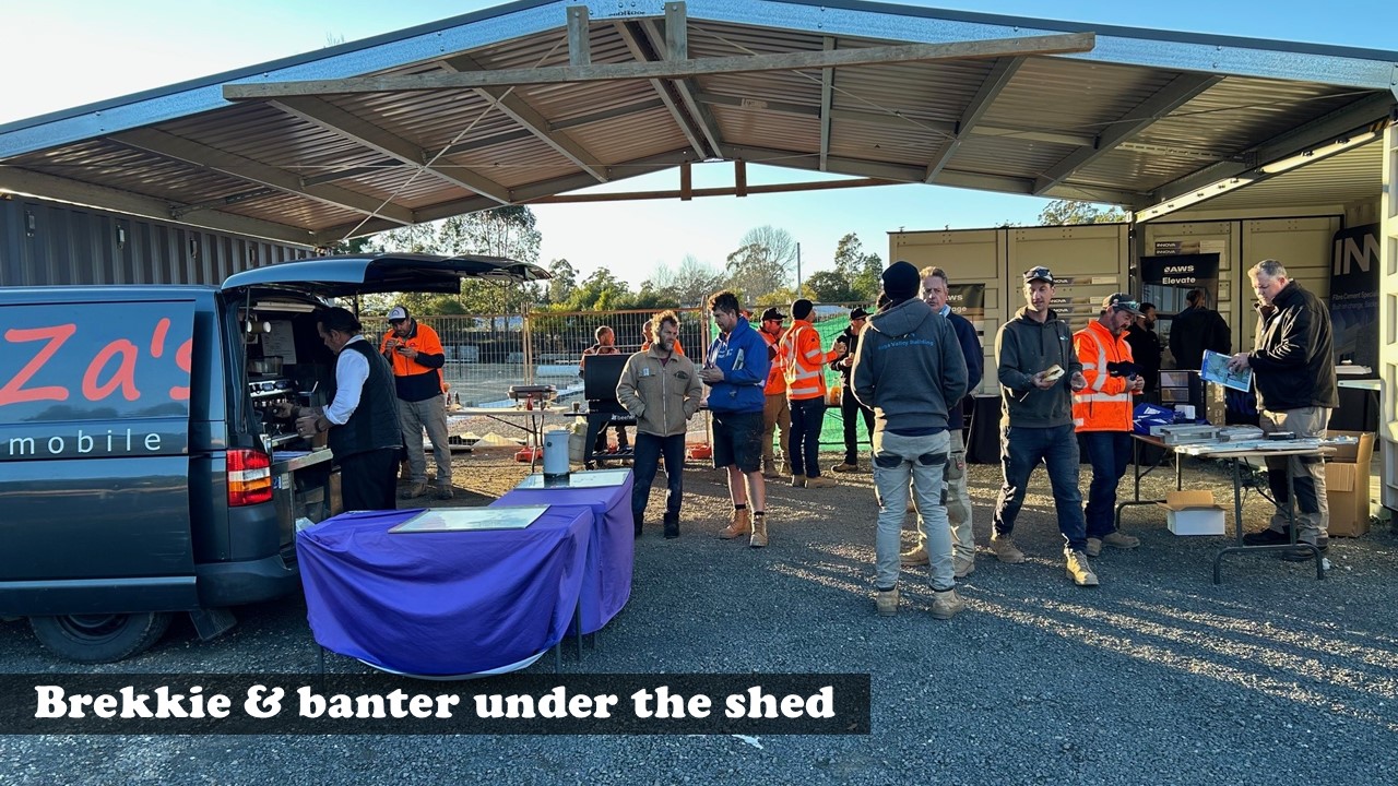 Builders and tradies enjoying breakfast and chatting under the shed at Stafford’s Kalaru monthly Trade Brekkie.
