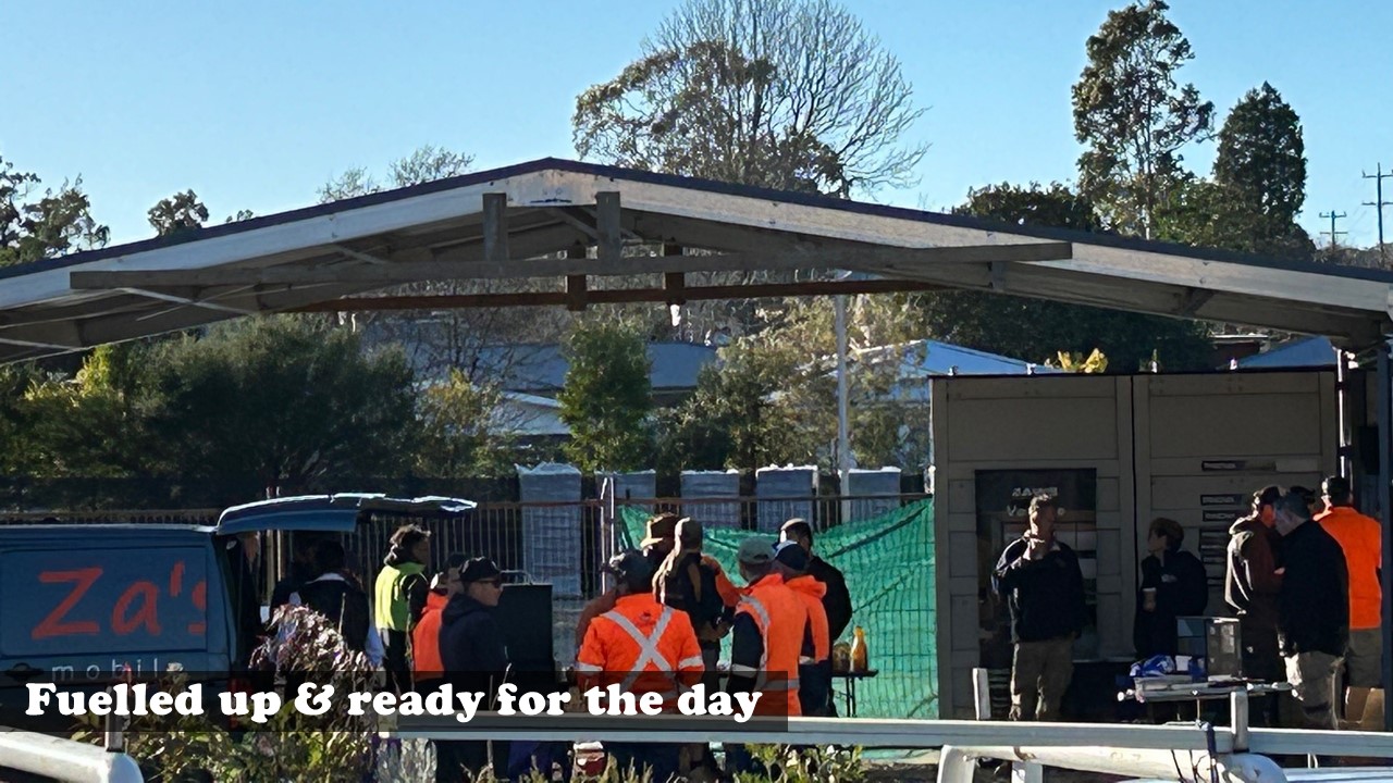 Tradies with coffees in hand getting ready for site after Stafford’s Kalaru Trade Brekkie with suppliers on show.